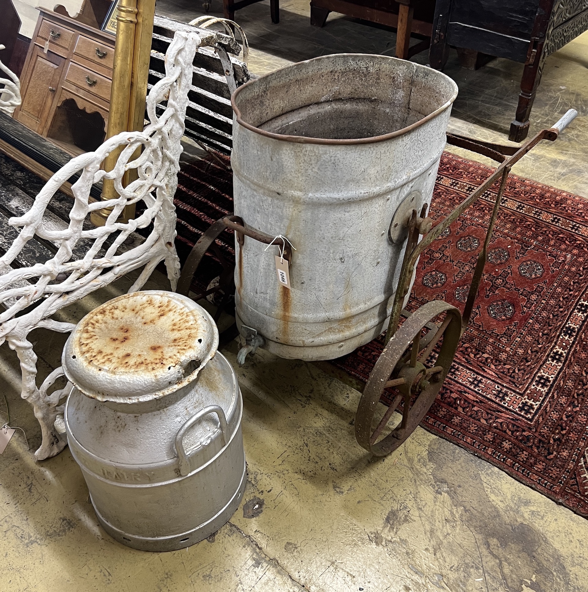 A Victorian galvanised and wrought iron water barrow, height 73cm together with a churn